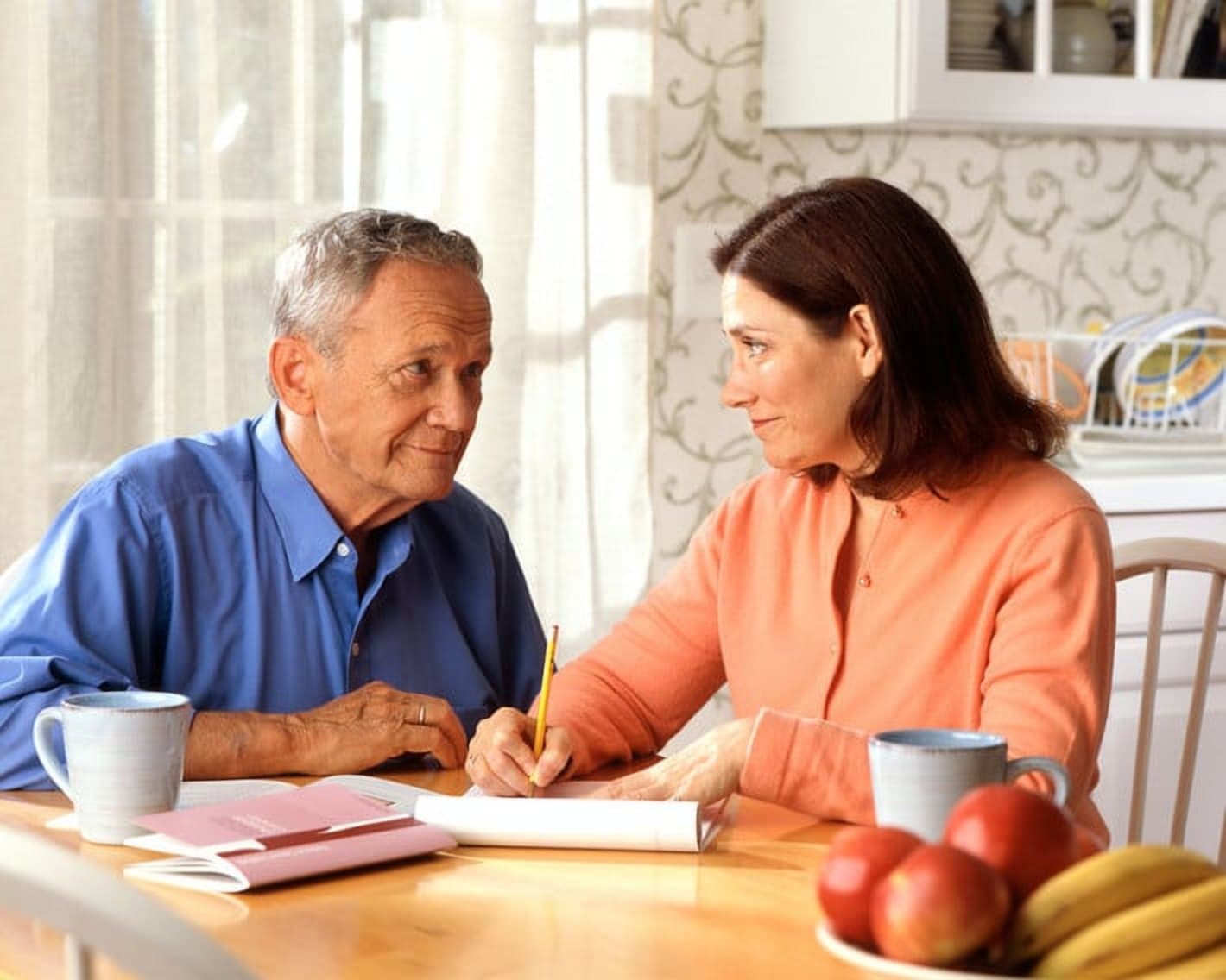 Couple discussing documents at a table, illustrating family law